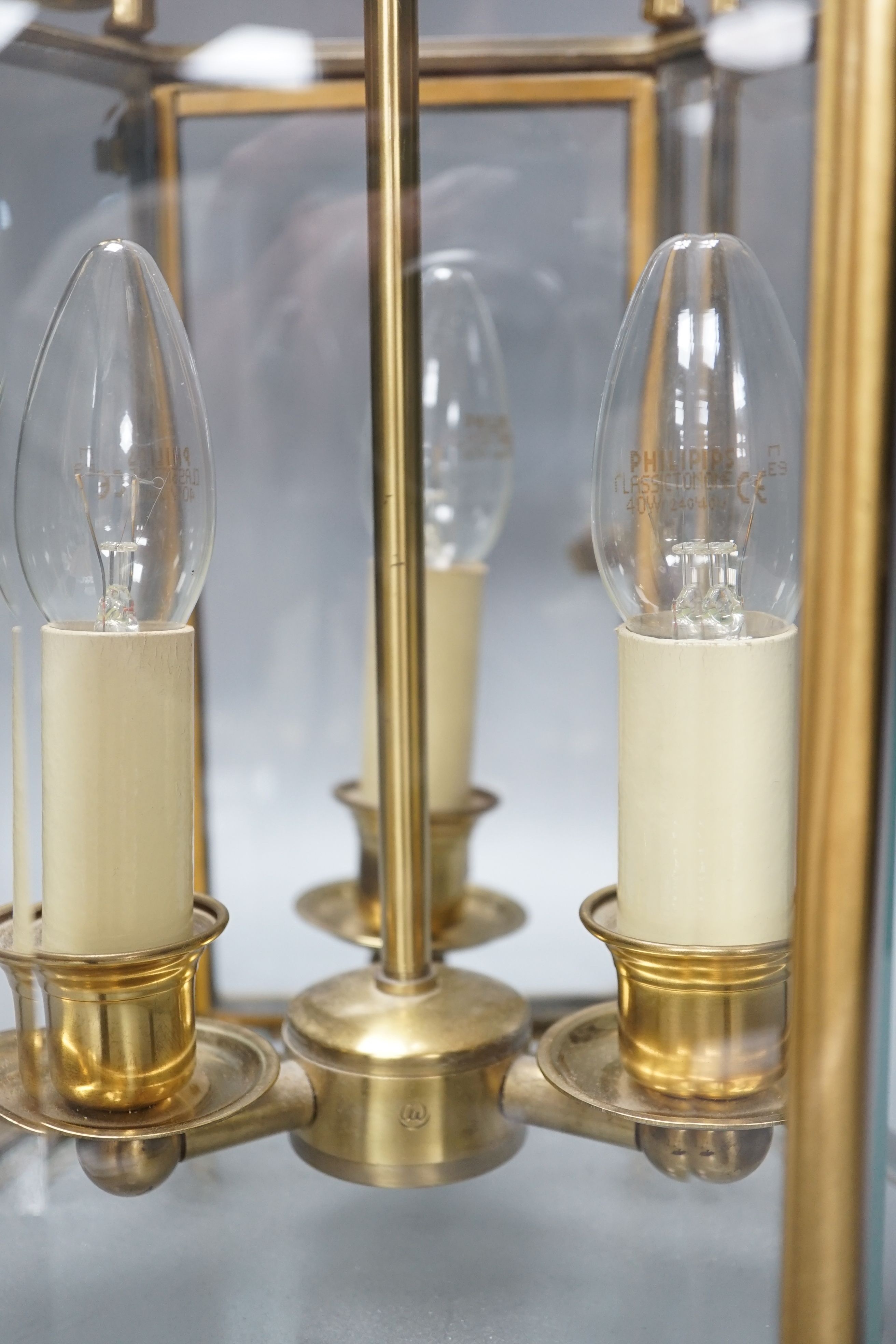 A three light brass hall lantern in hexagonal glass opening case - 56cm high excluding ceiling rose suspension